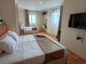 Un dormitorio con una cama grande y un televisor de pantalla plana. en Eco green pyramids hotel, en El Cairo