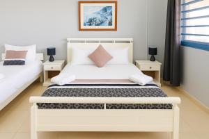 a bedroom with two beds and two tables at The Tree House Port Vila in Port Vila +33 photos