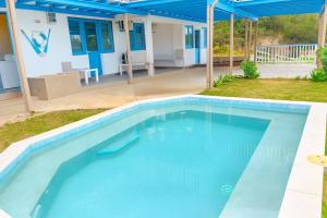 a large swimming pool in a yard with a house at The Tree House Port Vila in Port Vila