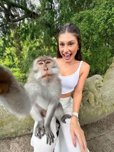 a woman holding a monkey on her arms at Ubud Classic Day Trip in Pesanggaran +4 photos