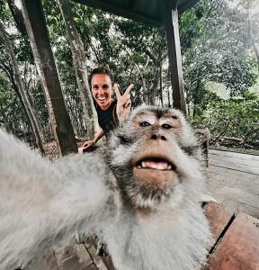 a young boy is playing with a dog at Ubud Classic Day Trip in Pesanggaran