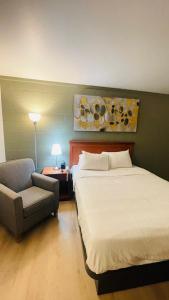 een hotelkamer met twee bedden en een stoel bij Nelson Hotel in Swan River +14 foto's