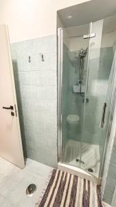a shower with a glass door in a bathroom at Gumantu Stay in Praia a Mare +25 photos