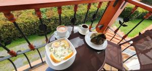 a table with a plate of food on a balcony at Hotel Villa Javier VDL in Villa de Leyva