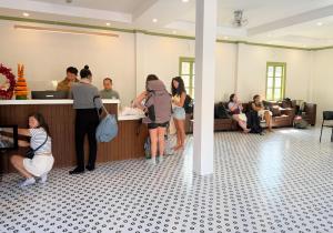 a group of people standing in a lobby at White Elephant Hostel in Luang Prabang +37 photos