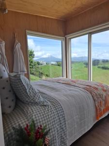a bedroom with a bed with a large window at Little Hurst House - Escape the Ordinary in Inglewood