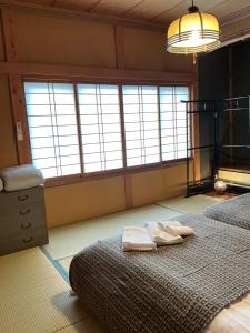 Ένα ή περισσότερα κρεβάτια σε δωμάτιο στο Guest house 湊