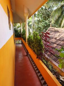 a hallway of a house with a yellow and orange wall at Aditi Ayurveda Panchkarma Retreat in Vilinjam