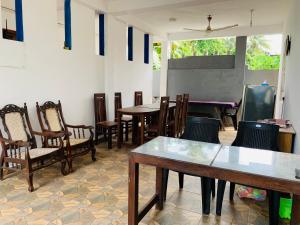 a dining room with tables and chairs and a pool table at Calidan in Mirissa +38 photos