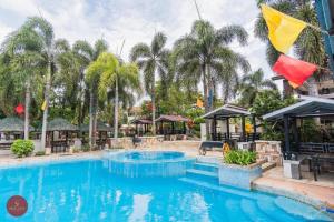 a pool at a resort with palm trees at Quezon Premier Hotel - Candelaria in Candelaria