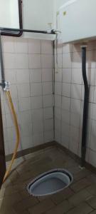 a bathroom with a toilet in the middle of the floor at Pagohhomestay Humaira282 in Pagoh +30 photos