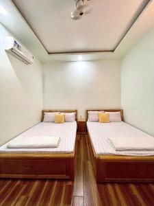 Giường trong phòng chung tại Nhà Nghỉ Thành Đạt - Bến Tàu Phú Quốc