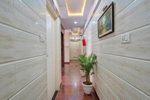 a hallway with wooden walls and potted plants at Via SLV Suites in Bengaluru