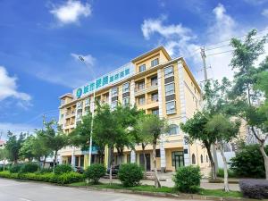 a tall yellow building with a sign on it at City Comfort Inn Nanning Wuming Lijian in Wuming