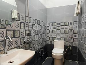 a bathroom with a white toilet and a sink at Wanna Ayodhya in Ayodhya