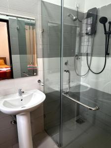 a bathroom with a sink and a glass shower at Prime Residencies Panadura - Convenient Apartment in Panadura