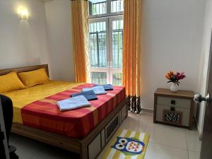 a bedroom with a bed and a window at Prime Residencies Panadura - Convenient Apartment in Panadura