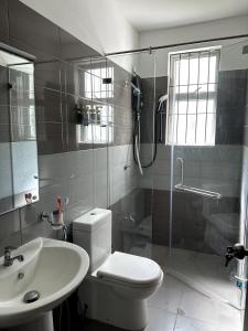 a bathroom with a toilet and a shower and a sink at Prime Residencies Panadura - Convenient Apartment in Panadura +21 photos
