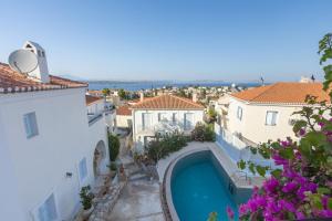 a view of a swimming pool between two buildings at Villa Giasemi in Spetses