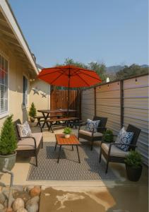 a patio with chairs and a table and an umbrella at Cozy Condo minutes from the Sequoia National Park in Three Rivers