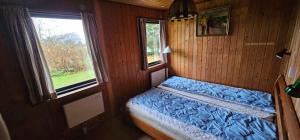 Idyllic Coastal Cottage Comfort And Relaxing في كالوندبورج: غرفة نوم صغيرة بها سرير ونافذة