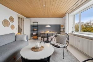 una sala de estar con un sofá y una mesa en Beautifull 2-Room Apartment With Sea View, en Sandvig