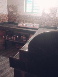 a person is hiding under a table in a room at Gokarna 2Bhk,Kitchen,AC and Non AC Stay in Gokarna