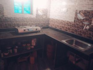 a kitchen with a sink and a counter top at Gokarna 2Bhk,Kitchen,AC and Non AC Stay in Gokarna