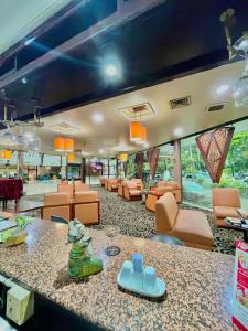 a lobby with a waiting area with orange chairs at Horison Ultima Bandung in Bandung