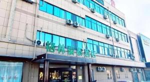a building with a sign on the front of it at GreenTree Inn Express Jinan Zhangqiu Districty Ancinet Town Longquan Road in Zhangqiu