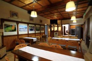 a dining room with tables and chairs in a restaurant at Kolpinghaus in Caransebeş