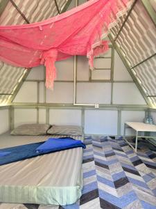 a room with a bed and a red mosquito net at Nice Beach Bungalow in Koh Rong Island +82 photos