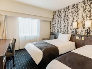 Ένα ή περισσότερα κρεβάτια σε δωμάτιο στο APA Hotel Naha Matsuyama +74 φωτογραφίες