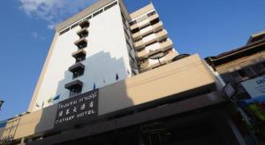 a tall building with a sign on the side of it at Cathay Hotel in Betong