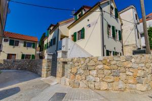 a stone building with a clock on the side of it at Hostel Dvor in Split