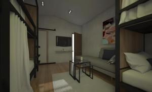 una pequeña habitación con una cama y un sofá en Journey Hostel Surat, en Ban Tha Kup