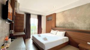 a hotel room with a bed and a television at B2 Buriram Boutique and Budget Hotel in Ban Khok Wat