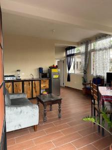 Casa Salo B2 في San Martín Zapotitlán: مطبخ مع أريكة وطاولة في الغرفة