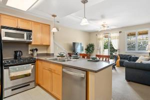 an open kitchen and living room with a couch at Tranquil Oasis Resort Villa in Honokai Hale