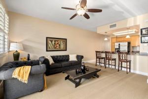 a living room with a couch and a table at Tranquil Oasis Resort Villa in Honokai Hale