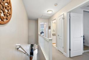 a hallway with a white door and a mirror at Tranquil Oasis Resort Villa in Honokai Hale
