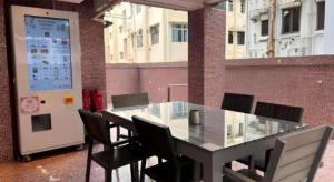 a glass table and chairs in a room with a building at Acesite Knutsford Hotel in Hong Kong