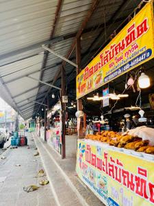 a market with a bunch of donuts on display at Cozy Hideaway 2 BR in Ban Ta Khun