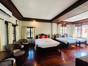 Postel nebo postele na pokoji v ubytování Villa Phounsab Tourist Street