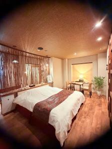 Ένα ή περισσότερα κρεβάτια σε δωμάτιο στο リンドス