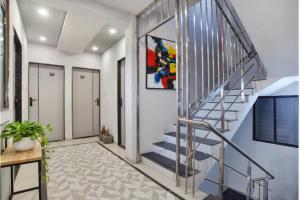a staircase in a house with a stair case at Fabhotel Grand Blue in Indore