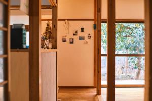 a kitchen with a refrigerator and a sliding glass door at 湊庵 赤橙 -so-an sekitou- in Inatori