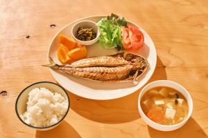 a plate of food with fish and vegetables and rice at 湊庵 赤橙 -so-an sekitou- in Inatori