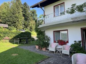 a patio of a house with chairs and a table at Holiday apartment with 1 bedroom in Aich