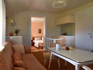 a living room with a couch and a table at Holiday apartment with 1 bedroom in Aich